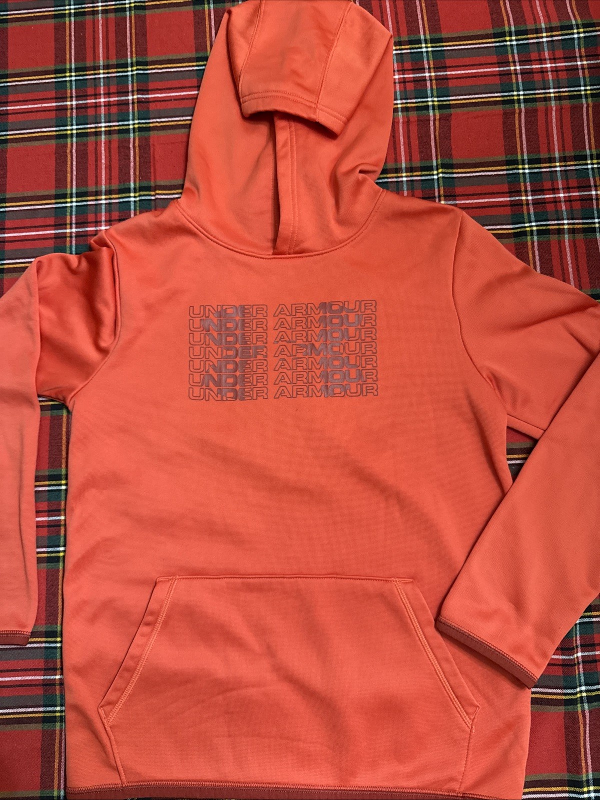 Under Armour hoodie in orange with a black Under Armour logo.