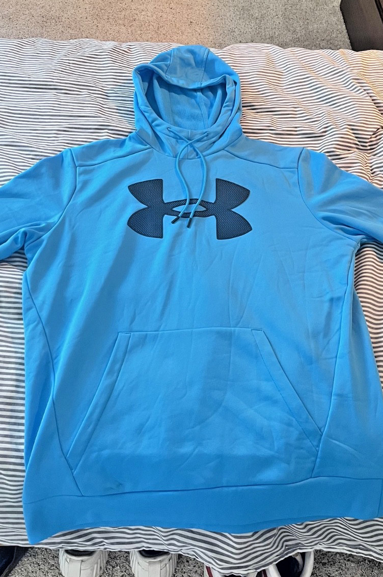 Medium electric blue Under Armor hoodie with embroidered mesh logo on the front.